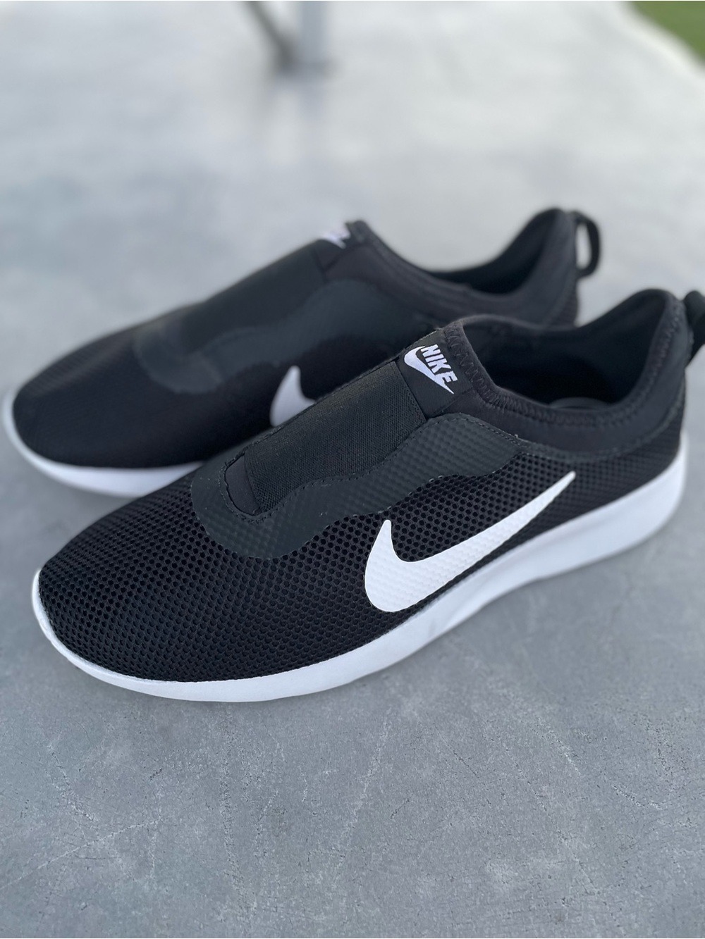 Nike Black Slip-On Sneakers with White Swoosh Accent